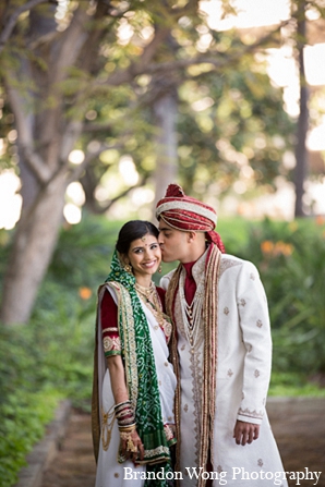 An Indian bride and groom have a traditional Hindu ceremony in Southern California. They choose a classic theme for their wedding while their reception is more modern with hot pinks and blues.