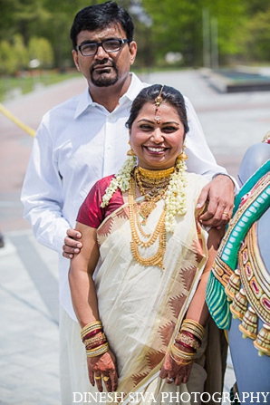 This Indian bride and groom pose for photos at their traditional Hindu wedding ceremony.