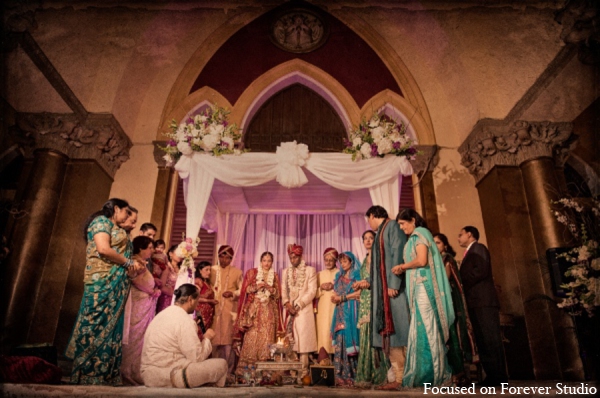 The wedding party under the traditional mandap