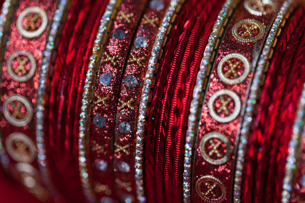 The Indian bride\'s traditional red and gold bangles.