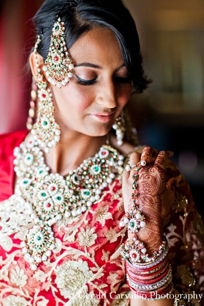 Bridal portraits of the bride in her ceremony lengha. Details of the embroidery in her lengha, jewelry, and henna are all shown.