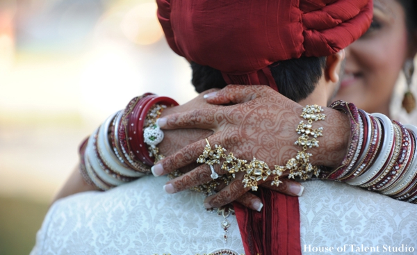A portrait of the Indian bride and groom. in traditional ceremony dress. She wears traditional wedding jewelry.