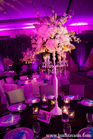 indian wedding reception white floral arrangements purple lighting