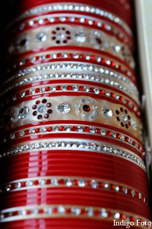 The bride wears traditional Indian bridal jewelry for the Sikh ceremony.