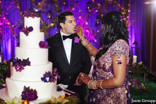 The Indian wedding reception. The bride and groom cut their wedding cake.