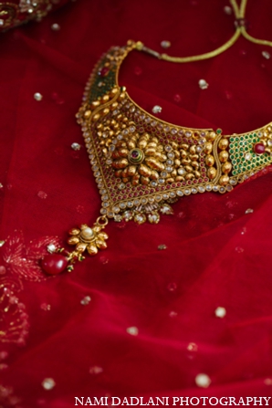 The bride wears traditional red and gold for the Indian wedding ceremony.