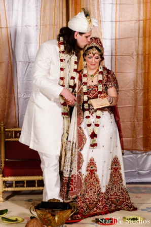 The bride and groom at their Indian wedding ceremony. They perform traditional wedding rituals and customs.