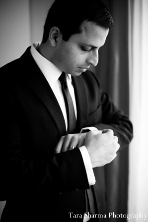 A portrait of the groom in his reception suit. This is a black and white photograph.