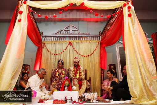 Indian bride and groom, yellow and red mandap
