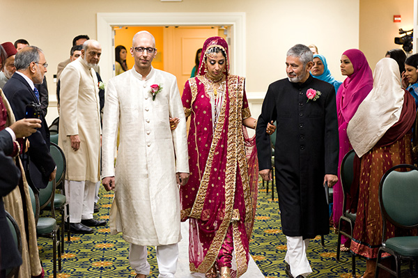 An Indian bride walks down the aisle at her traditional Muslim Indian wedding.