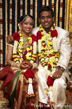 Indian bride and groom wear their jaimala flower garlands.