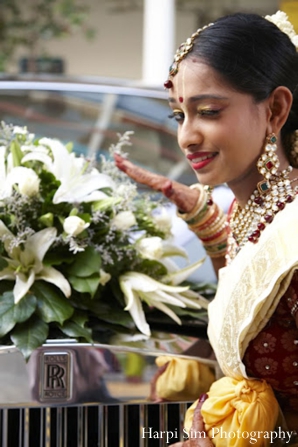 An Indian bride wears traditional indian bridal jewelry.