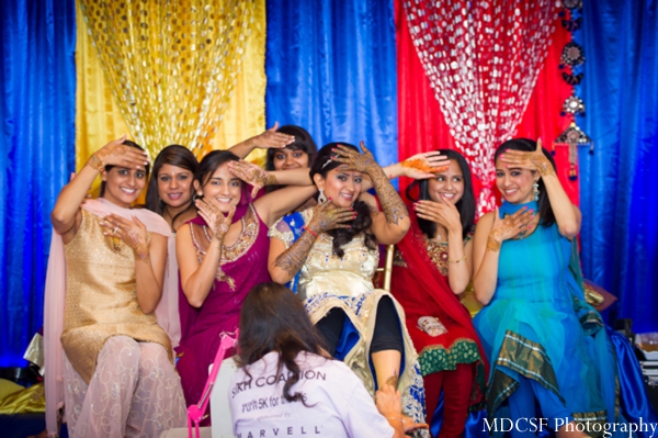 Indian bride and her friends at a mehndi party before Indian wedding.