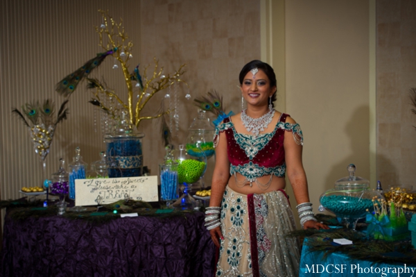 Indian bride at her peacock themed ganesh puja Indian wedding party.