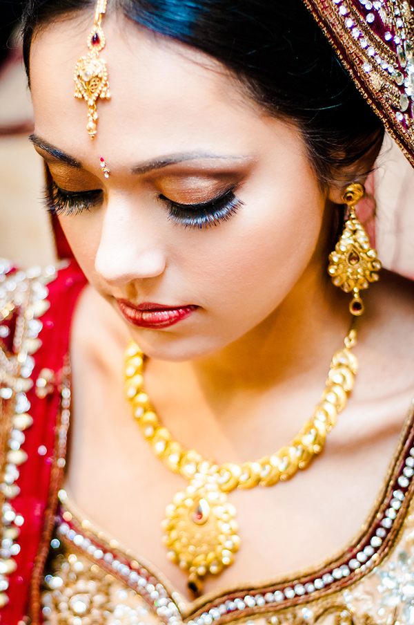 Indian bride makeup accentuates this Indian bride's eyelashes and lips.