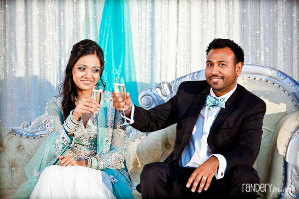 An Indian bride and groom toast at their Indian wedding reception.