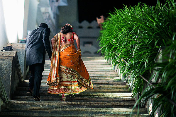 An Indian bride and groom enter their Indian wedding reception in Udaipur, India.