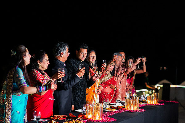 Family and friends toast to newlyweds at this Indian wedding reception in Udaipur, India.