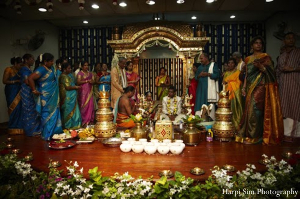 Indian wedding traditions play out under a gold mandap.