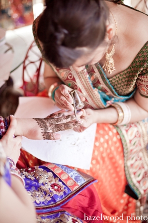 An Indian bride gets bridal mehndi before her fusion Indian wedding.