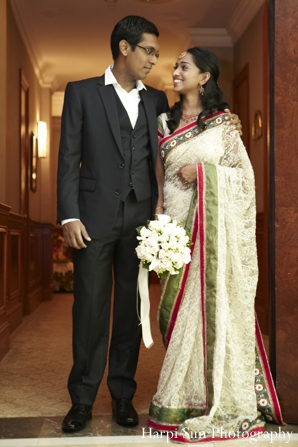 An indian bride wears a light green bridal sari with her new husband.