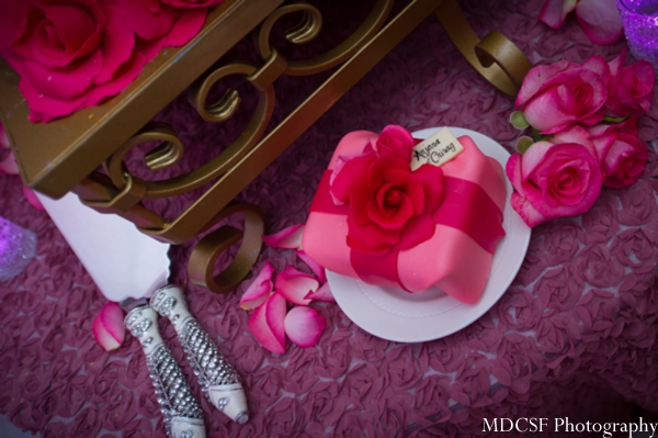 Close up of indian wedding cake with mini cake treat.