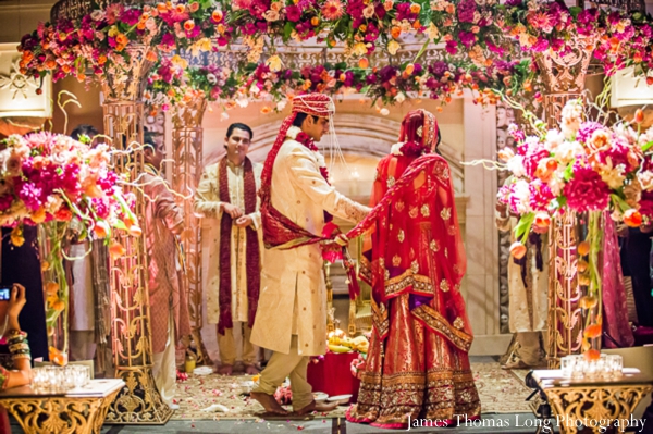 indian wedding ceremony covered in flowers at the mandap.