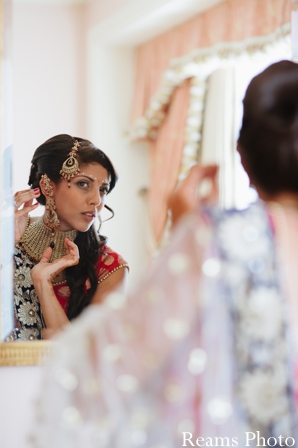 indian wedding jewelry is put on by indian bride.