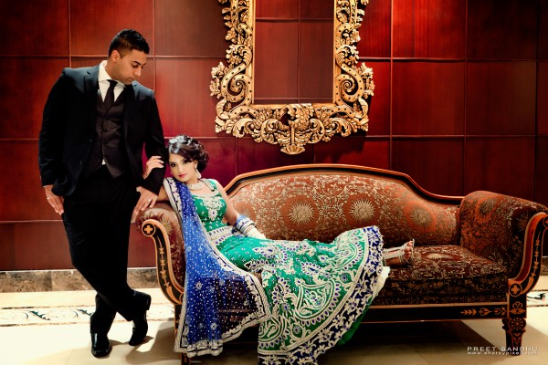 Indian bride in green and blue wedding lengha.