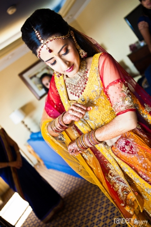 Indian bride gets ready in traditional indian lengha.