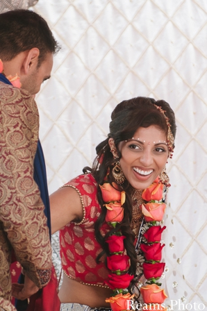 An indian bride wears a traditional indian wedding jaimala.