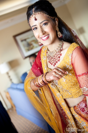 Indian bride wears yellow and red bridal lengha.