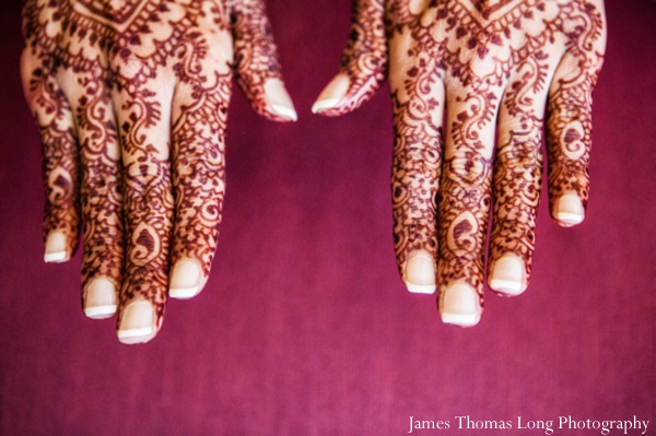 indian bride wears mehndi on hands.