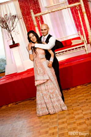 Indian bride and groom dance at their modern indian wedding reception.