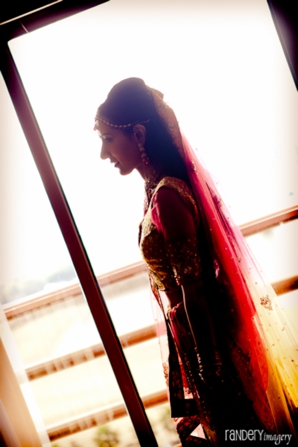 Indian bride in red and gold bridal lengha.