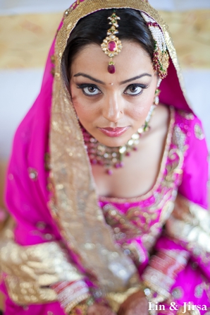 Indian bride wears pink wedding outfit to sikh wedding.