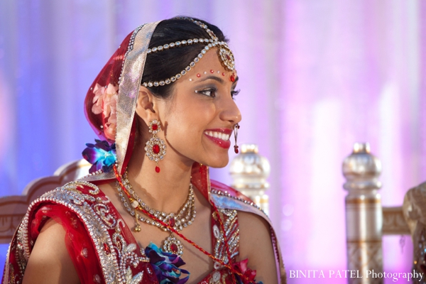 Indian bride wears traditional bridal lengha and indian wedding jewelry.