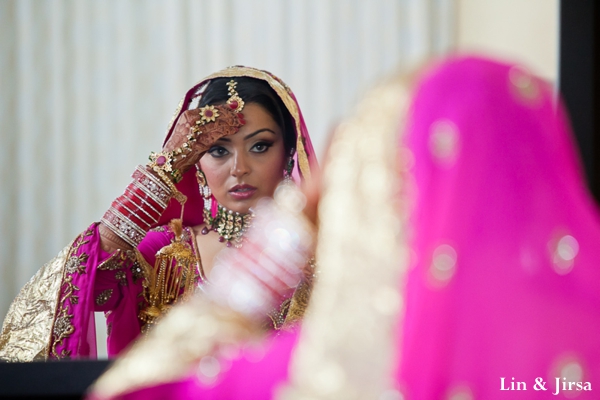 indian bride adjusts indian bridal jewelry set.