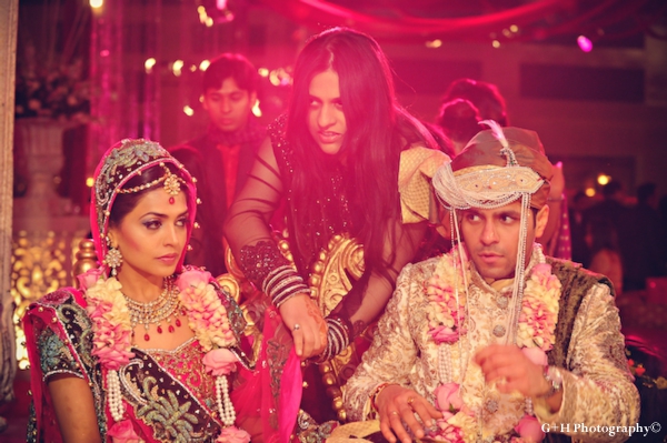 Indian bride and groom in pink and gold marry at indian wedding ceremony