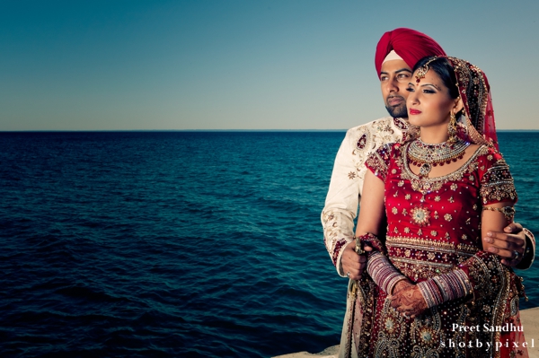 Indian bride and groom portraits by the sea.