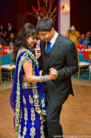 Indian bride and groom dance at their indian wedding reception.