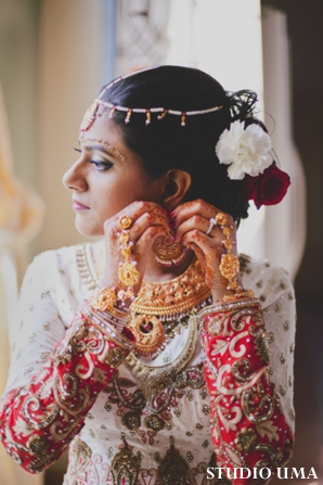 Indian bride puts on indian bridal jewelry.
