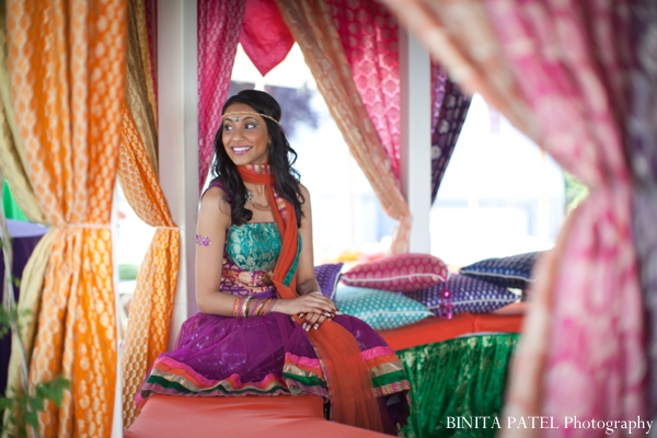 Indian bride smiles at her bridal mehndi party.