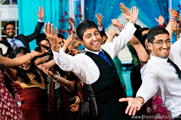Professional indian wedding photography captures dancing at indian wedding reception.