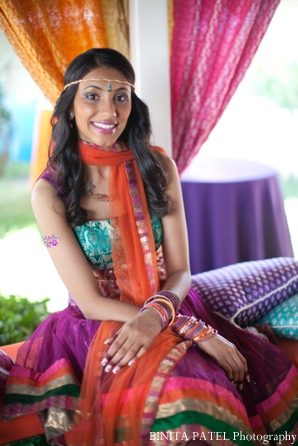 Indian bride in a traditional Indian wedding outfit for her bridal mehndi party.