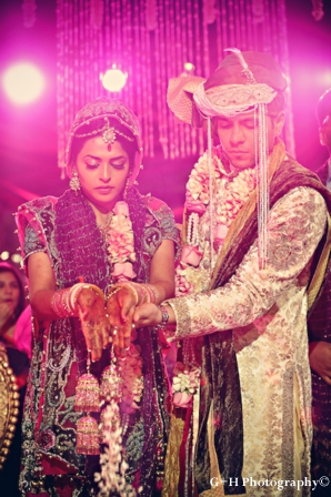 Indian bride wears pink wedding lengha to a pink indian wedding ceremony