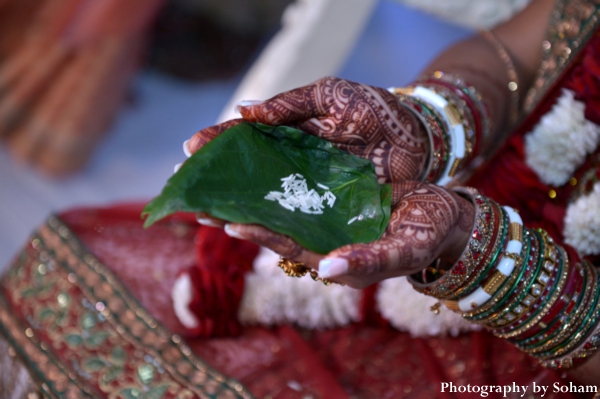 Indian bride with bridal mehndi, or bridal henna, on hands.