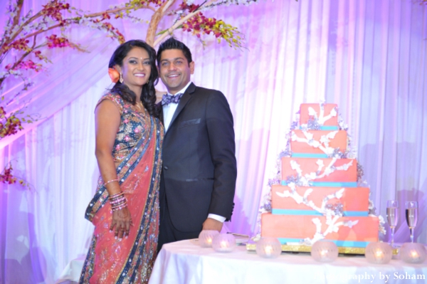 Indian wedding cake with indian bride and groom at indian wedding reception.
