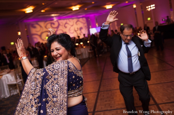 Indian wedding reception guests dancing in blue sari