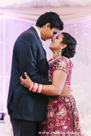 Indian bride in plum and gold wedding lengha.
